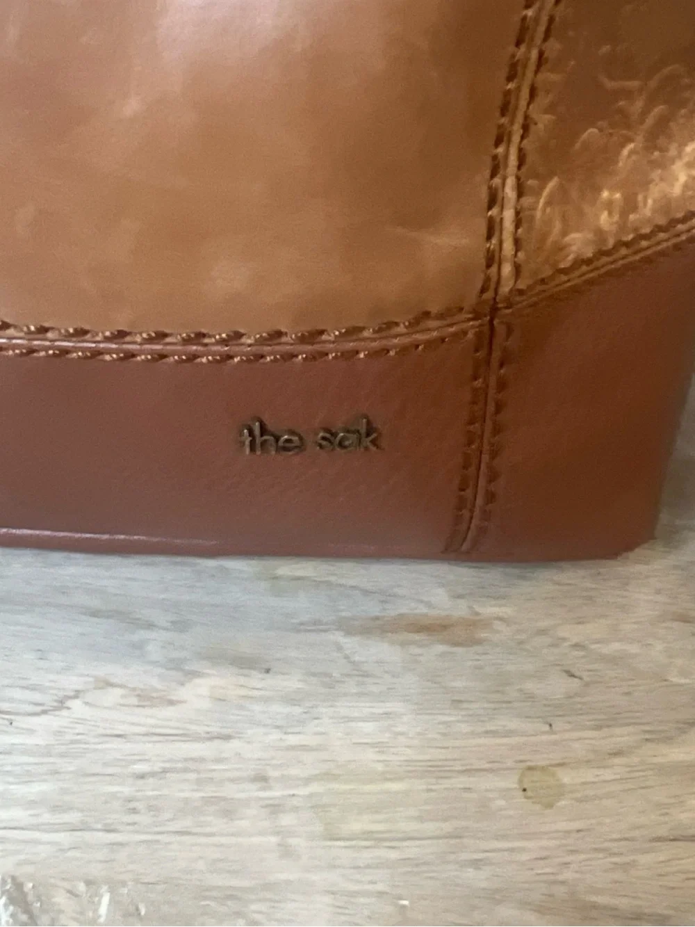 The Sak tan leather crossbody with beige interior